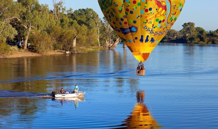 Colourful balloon drifts slowly over the River Murray near Wentworth, NSW, Australia
